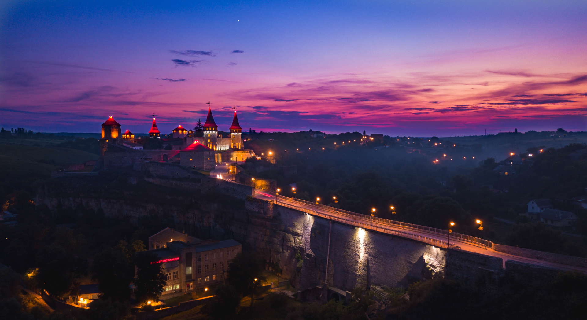 Kamianets-Podilskyi Castle, Kamianets-Podilskyi Castle sunset, Kamianets-Podilskyi Castle backpacking, Kamianets-Podilskyi Castle best photo, Kamianets-Podilskyi Castle tent, Kamianets-Podilskyi Castle wild camping, Kamianets-Podilskyi, best sunset picture, sunset over castle, sunset ukraine, ukraine wild camping, ukraine travel, ukraine backpacker, seven wonders of ukraine, shorts-trip, Kamianets-Podilskyi Castle drone, aerial view of Kamianets-Podilskyi